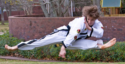 Sky Wood performs the scissor kick, which is a twist kick with the left foot and a side kick with the right foot executed simultaneously.